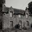 View from W showing blocked 17th century windows in gable and 19th century W facade.