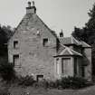 View from SE showing blocked openings of 17th century house and 19th century additions.