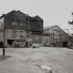 View of Pallet Shop, Wood Store and Paper Stores from NE.