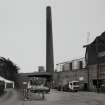 View of Loading Bay, Chimney and Oil Tanks from NW.