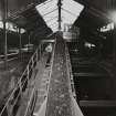 Newtongrange, Lady Victoria Colliery. 
Interior. Detail of conveyor carrying  coal up from beneath tippler.