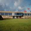 View from S of Office and Canteen block, also showing flagpoles.