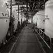 Interior.
View from E of tanks in whisky reduction department.