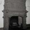 Interior.
View of elaborate stone carved fireplace in stair hall with heraldic shield on overmantle.