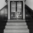 Interior. W staircase, view from landing showing double doors with bar area beyond