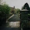 View from NE showing entrance gates and main approach