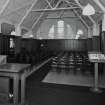 Interior. 
View from SSE showing the nave chairs and N window.