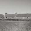 View of byre and workshop at E side of courtyard from SW