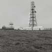 View of telecommunications mast and dovecot (HY63NW 35) from S