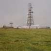 View of telecommunications mast and dovecot (HY63NW 35) from S