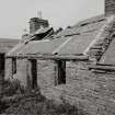 S-E range.  View of house at N end from S showing one piece wall-head stone