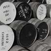 Detailed view of empty casks in yard, many from other distilleries whose whiskies are bottled at Springbank and sold under the 'Cadenhead' label