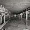 Campbeltown, Millknowe Road, Hazelburn Distillery, interior.
View of First Floor maltings block from South-West showing drop in floor level to neighbouring North-West maltings block and double cast iron columns between the blocks.