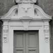 Detail of main South door pediment with stags head and motto
