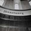 Apse, detail of wood panelling and lettering above
