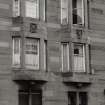 Glasgow, Rutherglen Road.
General view of bay windows with decorative carvings above.