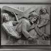 Interior. Detail of carved wood Station of the Cross 'Jesus falls a second time'.
