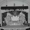 Interior.  Auditorium, view of stage from circle to N (safety curtain (iron) down)