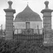 Detail of gate piers, framing view of mausoleum