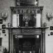 Interior view of Drawing room, detail of chimney piece and overmantel.
