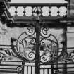 Detail of decorative iron work on railings outside main frontage.