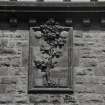 Detail.  On SE entrance block showing 'Tree of Life'