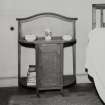 First floor bedroom, interior.
View of washstand.