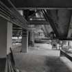 Interior view of the Boxes which stored sugar for bag filling, 1kg packing and gran dissolving, with their outlet slide valves and screw-conveyor systems shown in the foreground (T&L No.: 21177/1)