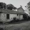 View of house and outbuildings from E.