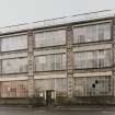 Elevation view from N of main facade of factory