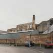 General view of the factory from W, showing its short boilerhouse chimney, and more modern steel-clad additions to the factory