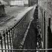 View of glazed enamel retaining wall of six-storey mill from E.