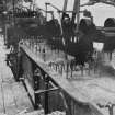 Copy of historic photograph showing interior view of wool washing.