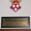 Interior. Main hall, detail of coat of arms and brass plaque on south wall