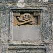 Detail of skull and crossbones in panel above entrance
