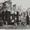 Copy of historic postcard showing general view of house from golf course.