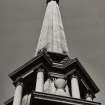 View from below of steeple showing urns