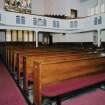 Interior. View from N showing pews and galleries