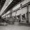 Foundry: general view from S within former casting shop, showing cast-iron stanchions supporting steel over-head crane track.  Moulten steel was previously supplied by an open-hearth furnace at the S end of the bay (now removed)