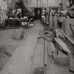 Smithy: view from N showing hearth (right), and part of pneumatic hammer (far left) and side hammer (left), both made by B & S Massey Ltd of Manchester