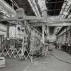 Motherwell, Craigneuk Street, Anderson Boyes
Fitting Shop (Dept. 51, built 1962): Interior view at N end of west bay from N, showing a newly-assembled Roof-bolting Machine with jib extended, undergoing tests prior to dispatch