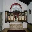 Interior. W side chapel, view of altar from N