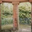 Gazebo, upper level, view from interior past pillars supporting entrance towards garden