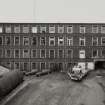 View from WSW of polychrome brick multi-storeyed mill at centre of works.  Photosurvey 22-APR-1992