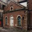 View from SW of polychrome-brick possible engine house at N end of four-storeyed mill at centre of works.  Photosurvey 22-APR-1992