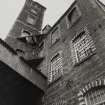 View from NW of tower at NE end of polychrome-brick four-storeyed mill ( E mill).  Photosurvey 22-APR-1992