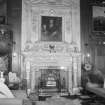Interior view of Newhailes House showing library fireplace by Sir Henry Cheere and overmantle by William Strachan and Thomas Clayton with portrait of Sir David Dalrymple and his son James by Sir John de Medina.