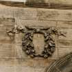 Detail of carved wreath on E facade.