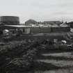Distant view from ENE of rear of factory, with gas works in background.