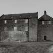 View of mill from E, showing main block of mill on left, and kilns on right.  A single-storeyed building attached to the E side of the mill has been recently demolished.